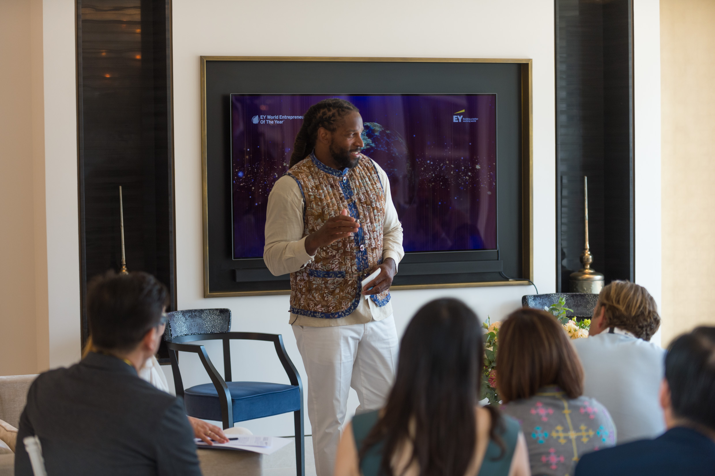 Marques Anderson speaking to a seated audience during an EY leadership conversation.